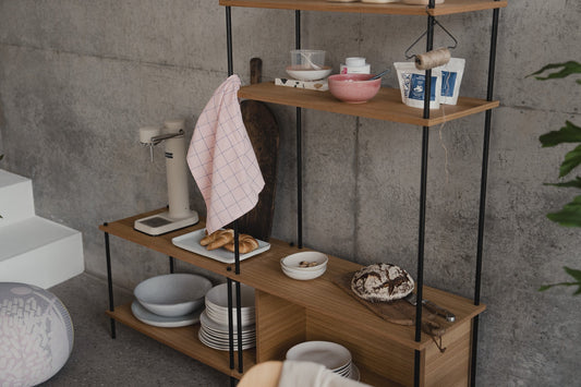 Freestanding asymmetric oak shelf, photographed in a room