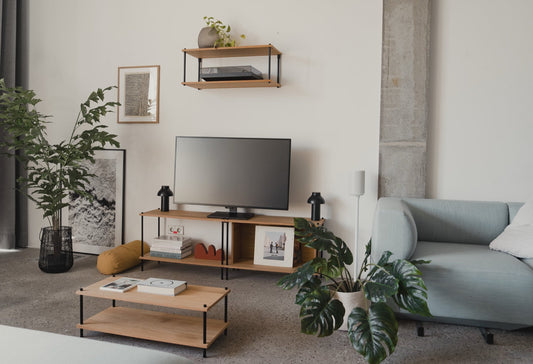 Modular oak shelving in a real living room — TV stand, wall shelf, coffee table, plants
