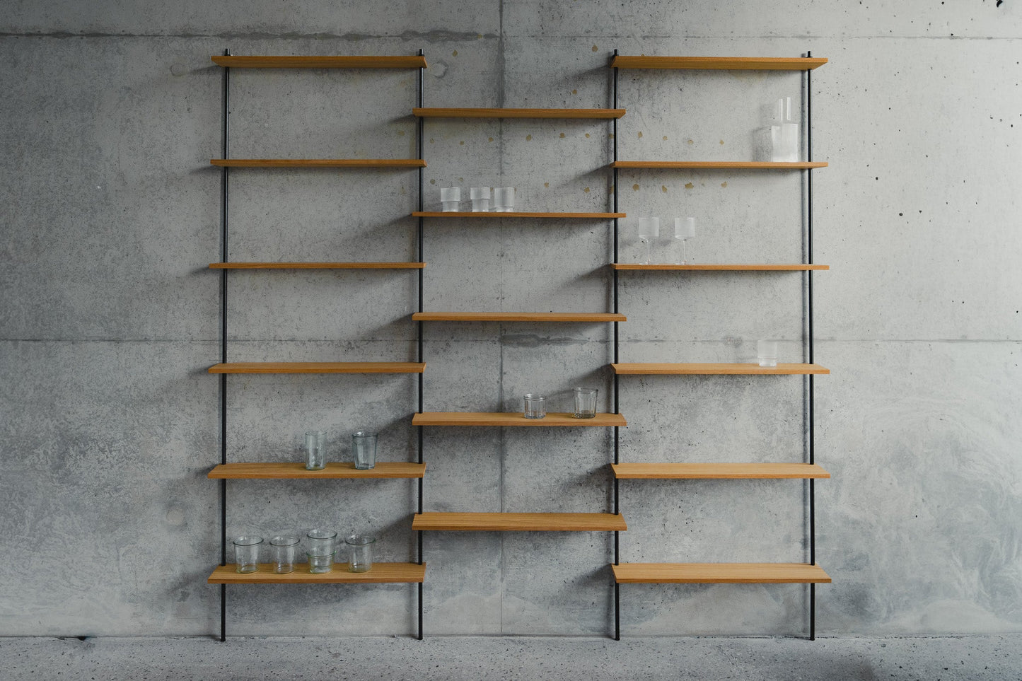 Large triple-section oak wall shelf with offset levels — KUUDU modular shelving system