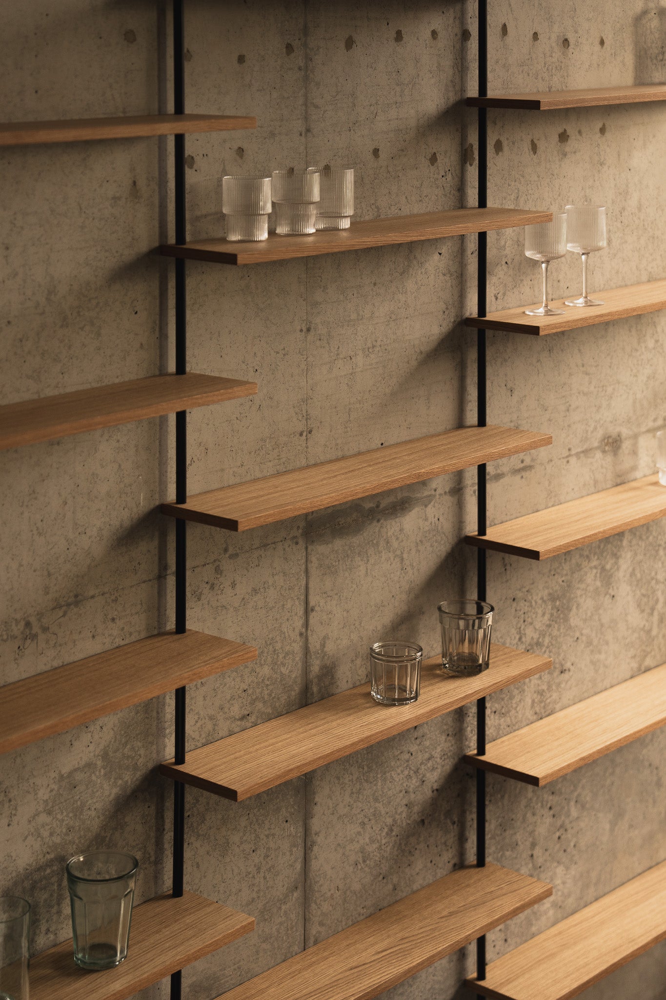 Large triple-section oak wall shelf with offset levels — KUUDU modular shelving system