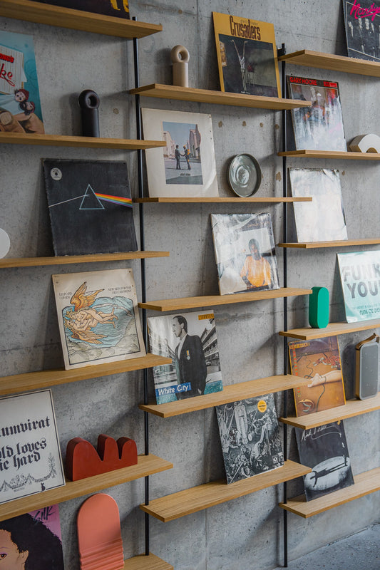 Large triple-section oak wall shelf with offset levels — KUUDU modular shelving system
